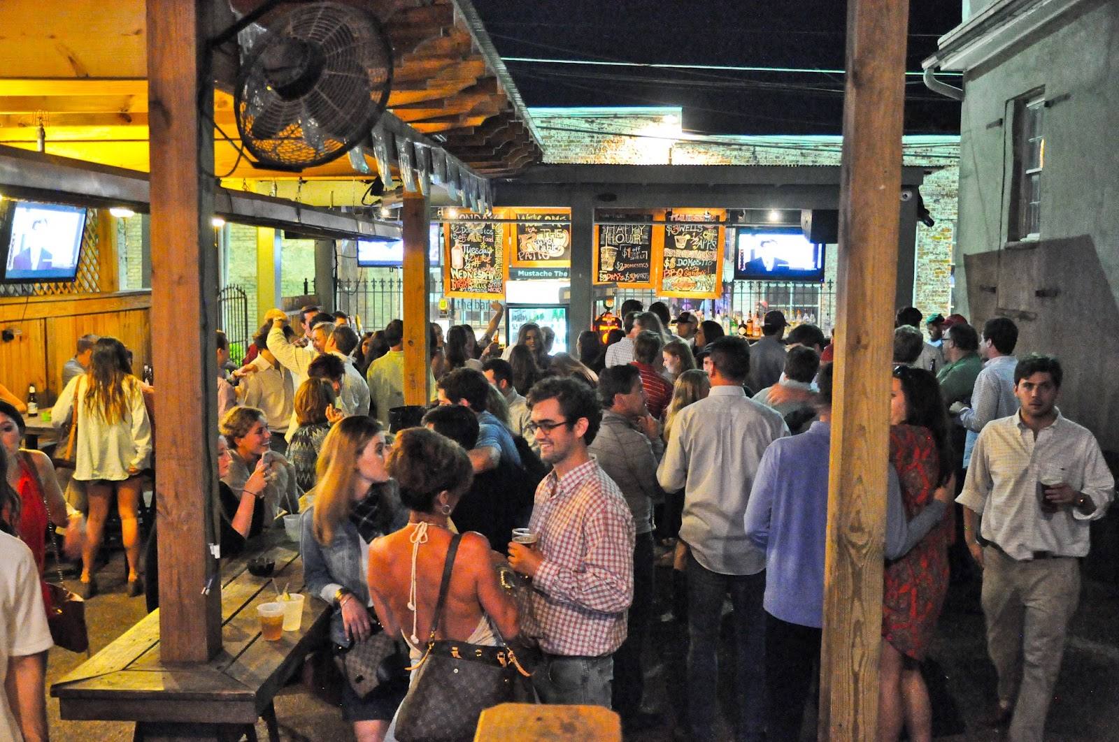 A packed Round Table patio with the TVs on